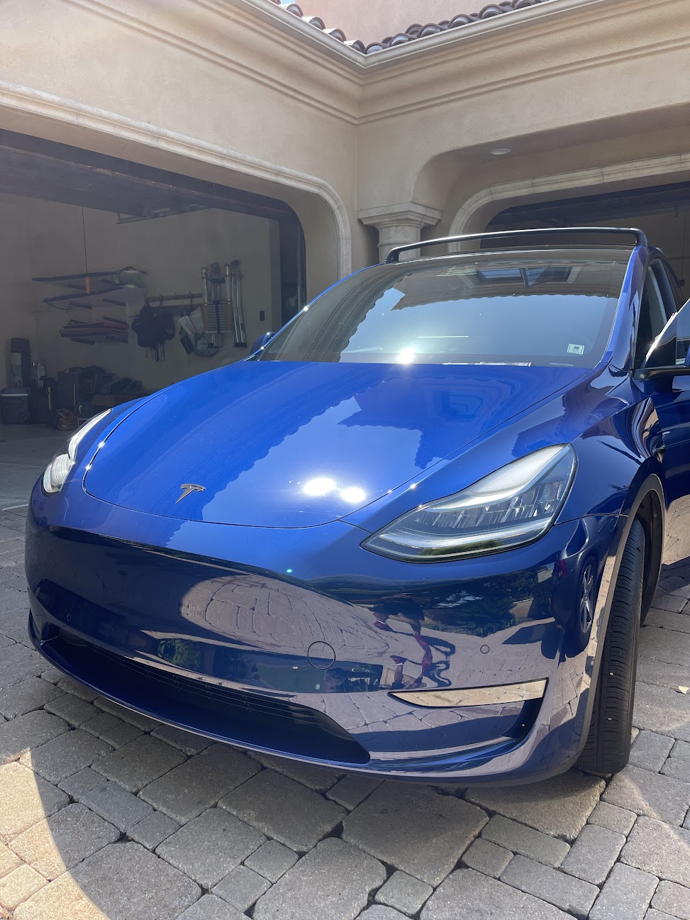 Blue Tesla Model Y after exterior detailing in an Encinitas driveway