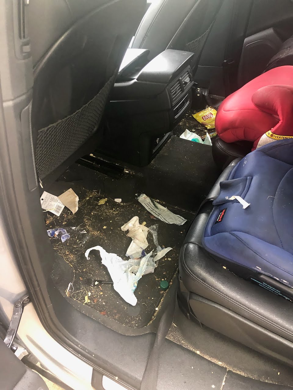 Messy back seat before a La Jolla interior detail