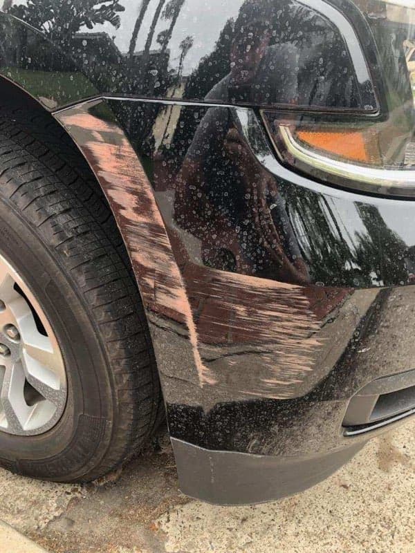 Black SUV paint with scuffs before paint correction