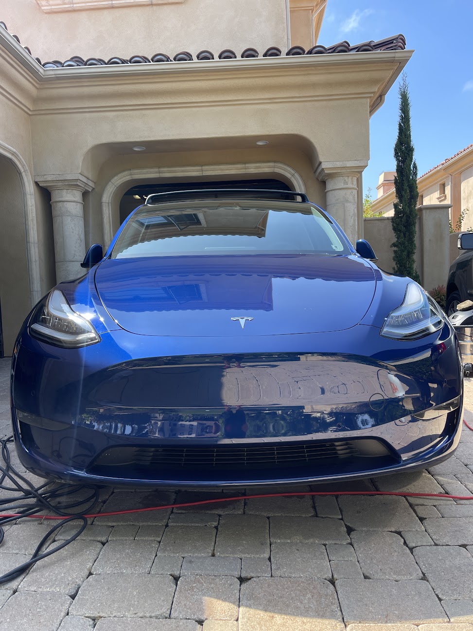 The same Tesla Model Y after a mobile detail, paint deep and glossy