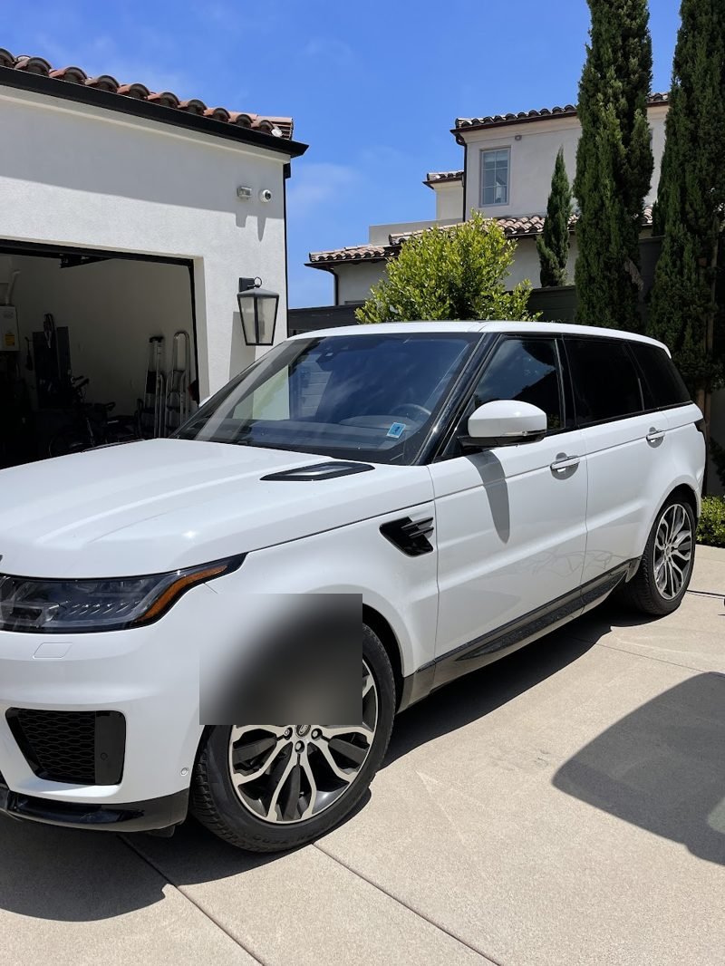 White Range Rover Sport, front three-quarter after a full exterior mobile detail