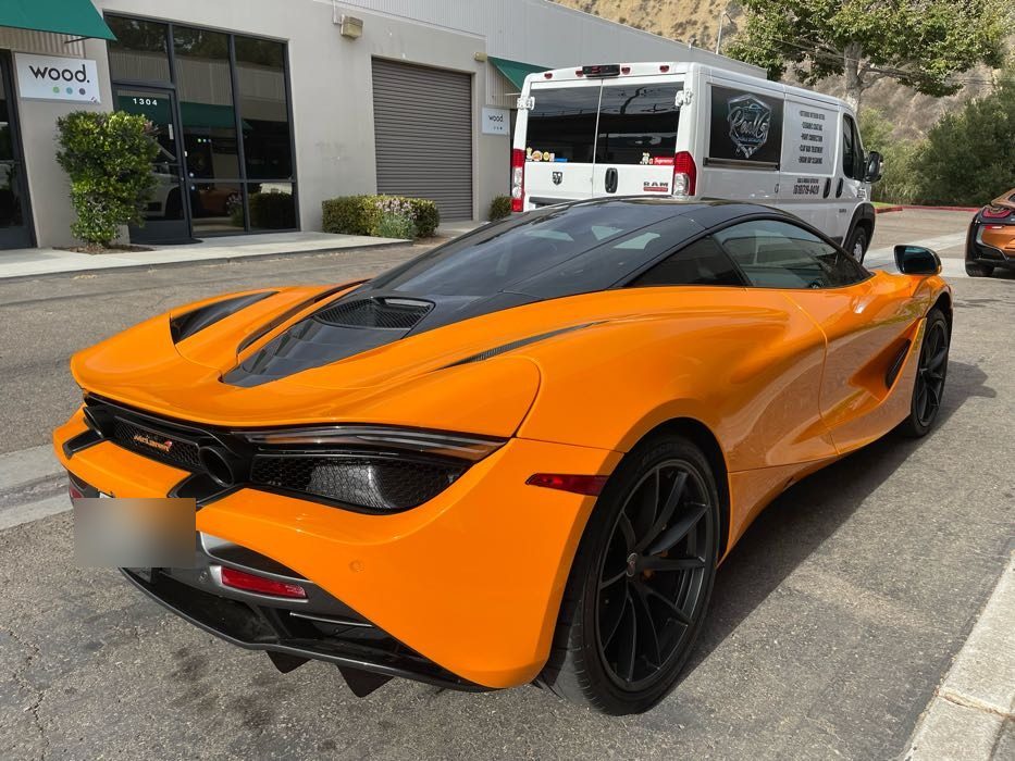 Orange McLaren 720S rear three-quarter after a full exterior detail at a Bay Park business on Morena Boulevard