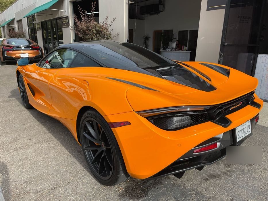 Orange McLaren 720S side profile gleaming after a mobile exterior detail in Bay Park